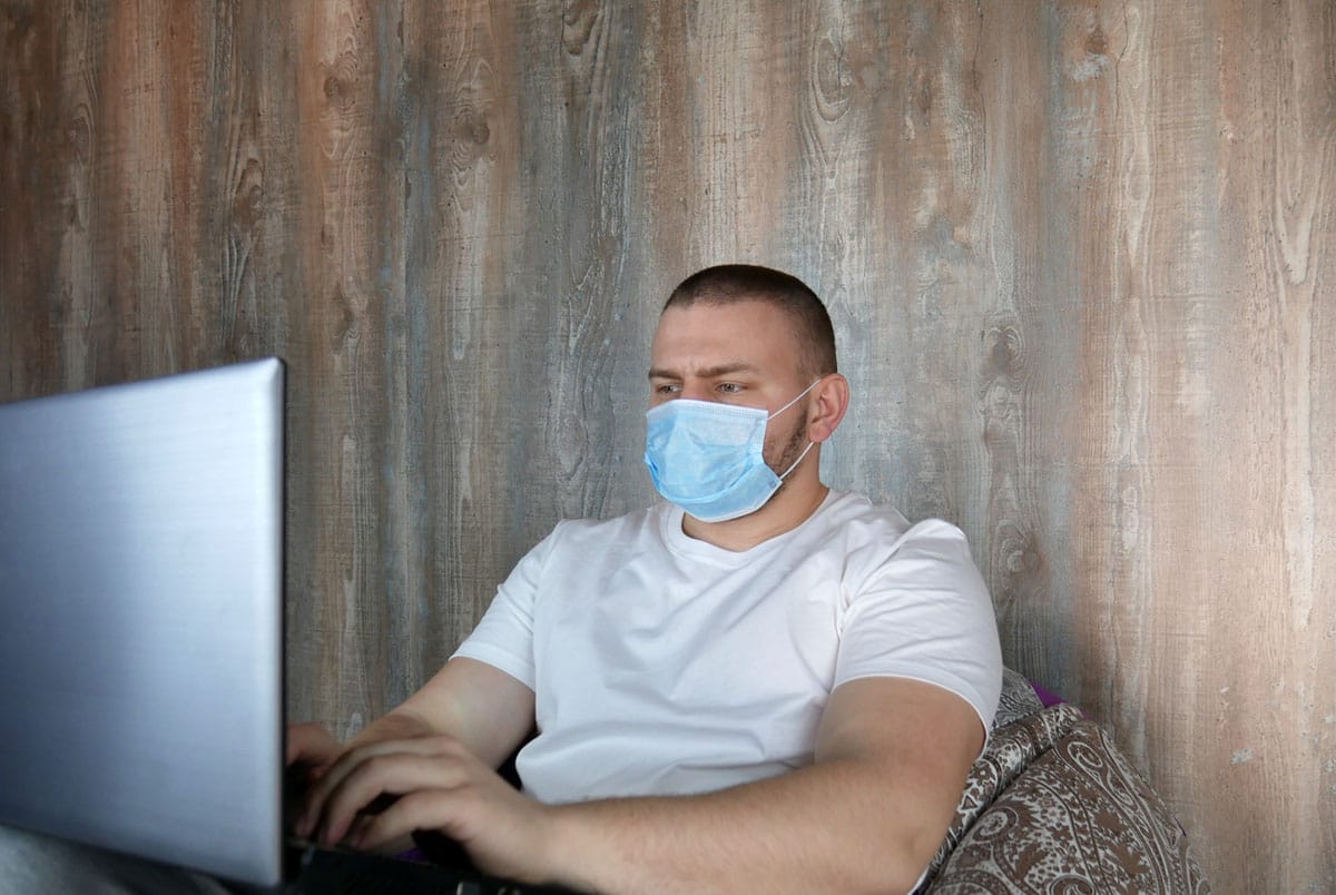 a student studying from his laptop durin quarantine